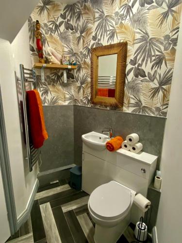 a bathroom with a toilet and a mirror at 5 Sea Spray in Burnham on Sea
