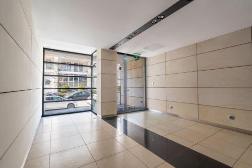 an empty room with a large window and a building at Wilanów Cinema Apartment in Warsaw