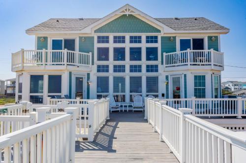 a house on a boardwalk with a white fence at 4000 - Fragile Magic in Kitty Hawk