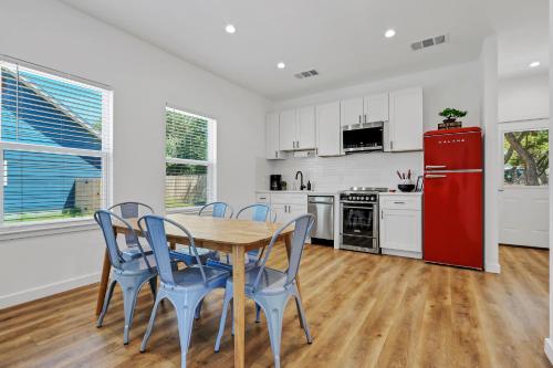 a kitchen with a table and chairs and a red refrigerator at Pitch Perfect in Canyon Lake