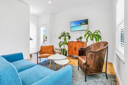 a living room with a blue couch and chairs at Pitch Perfect in Canyon Lake