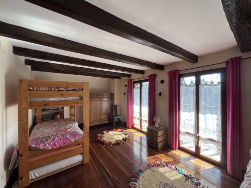 a bedroom with a wooden bunk bed and windows at Caserio Uletza in Rigoitia