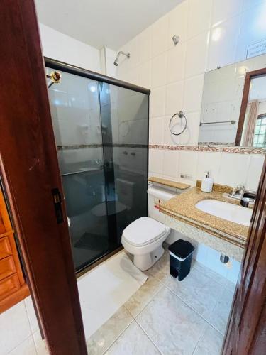 a bathroom with a shower and a toilet and a sink at Espaço Vida Mury - Casa Mara in Nova Friburgo