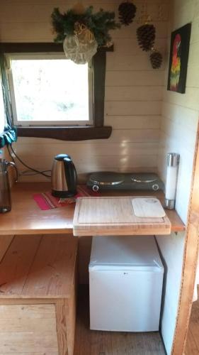 a desk in a tiny house with a window at Tiny house Suria - Český ráj in Prackov