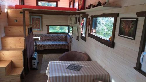an interior view of an rv with a table and a bed at Tiny house Suria - Český ráj in Prackov