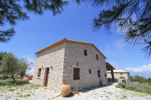 a small stone building with a tree at Villa Katerina in Chania
