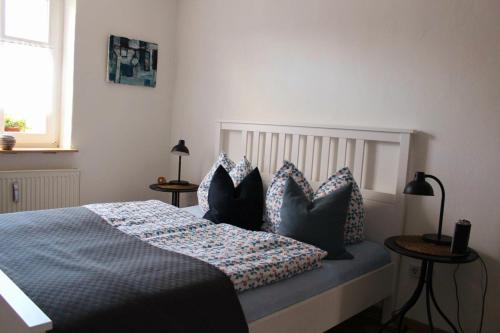 a bedroom with a bed with pillows on it at EG Die alte Stadtmühle von Kloster Zinna in Jüterbog