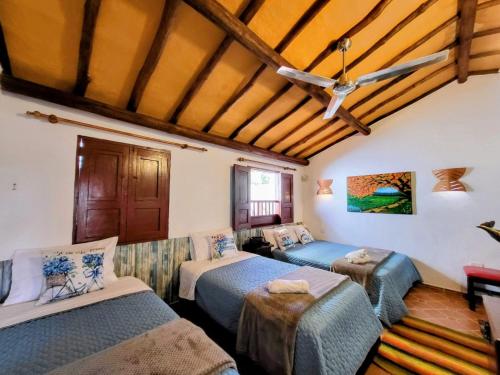 a room with two beds and a ceiling at AQUI ESTOY BIEN in Barichara