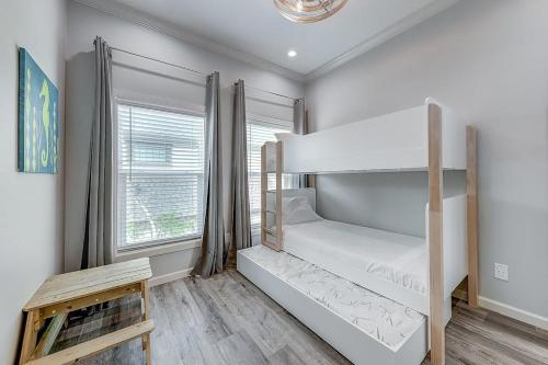 two bunk beds in a room with a window at The Flamingo Place in Rockport