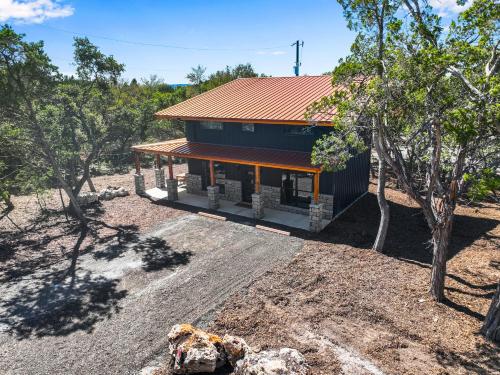 a house with a red roof on a dirt yard at Little Blanca in Canyon Lake