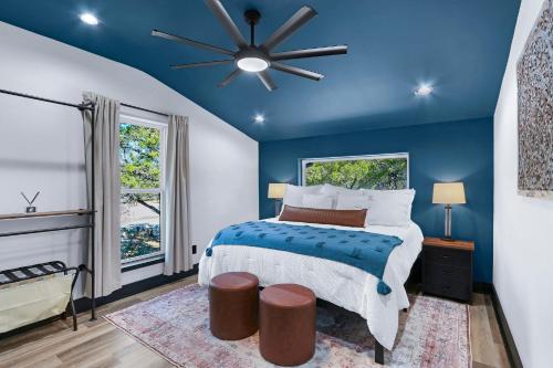 a blue bedroom with a bed and a ceiling fan at Little Blanca in Canyon Lake