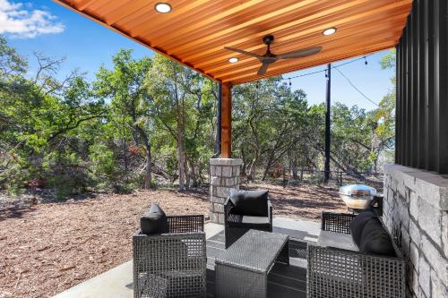 a covered patio with chairs and a ceiling fan at Little Blanca in Canyon Lake