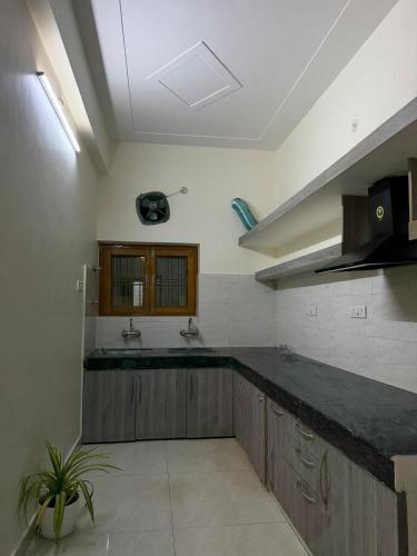a kitchen with a sink and a counter top at Palm Stone Villa in Lucknow