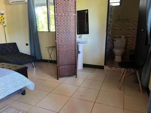 a bathroom with a sink and a toilet at Hotel Azul Coral in Cahuita