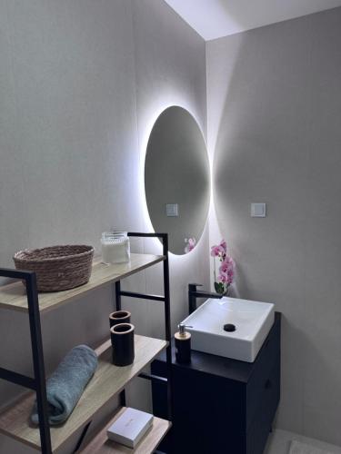 a bathroom with a sink and a mirror at Moderan 80m2 apartman - 2 kupatila - terasa - blizu centra i plaze in Bar