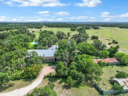 an aerial view of a farm house with a pool at Live Oak Ranch in Spring Branch