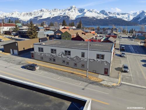 an aerial view of a city with snow covered mountains at Hotel North in Seward