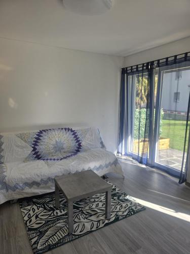 a living room with a bed and a table at Appartamento CHAN in Cama