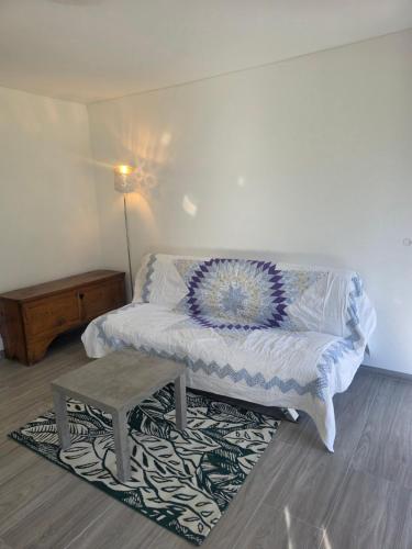 a bedroom with a bed with a table on a rug at Appartamento CHAN in Cama