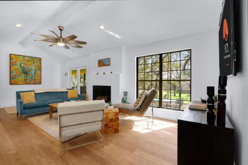 a living room with a blue couch and a table at Red Bird Cottage in Wimberley