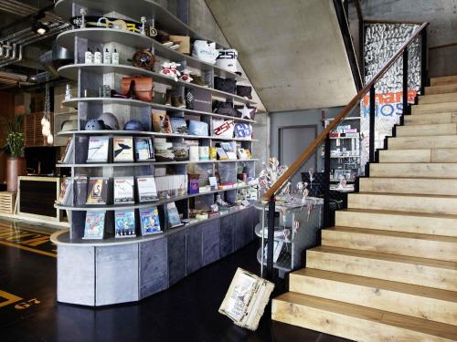 a staircase in a store with a shelf of products at 25hours Hotel Hamburg HafenCity in Hamburg