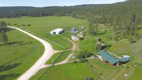 an aerial view of a farm with a road at 12 Mile Ranch in Custer