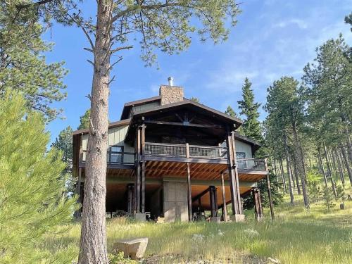 a house in the woods with a tree at Bishop Mountain Lookout in Hill City