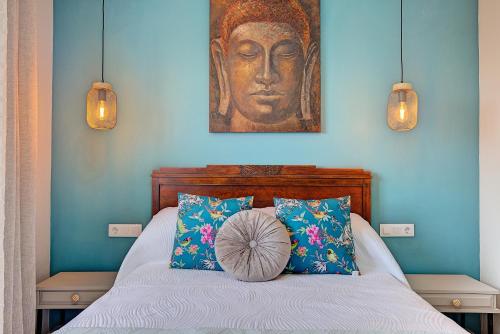 a bedroom with a bed with a painting on the wall at VV La Karajita in Mazo