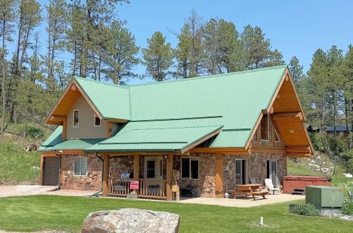 a log home with a green roof at Cottage at Storm Mountain #3 in Hill City