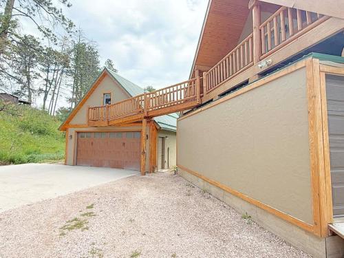 a house with a staircase on the side of a garage at Cottage at Storm Mountain #3 in Hill City