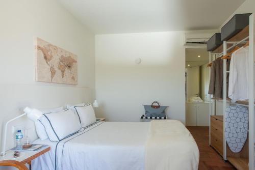 a white bedroom with a bed and a closet at Tavira Convent, 2-bedroom, condo, pool in Tavira