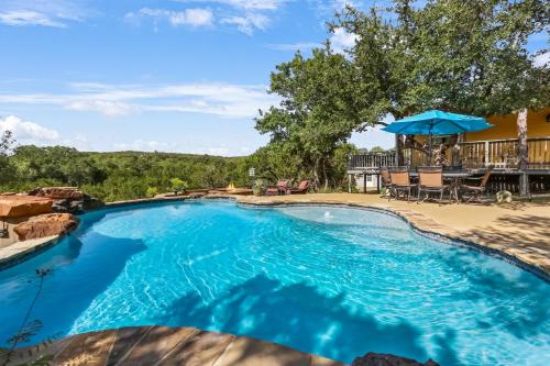 a large swimming pool with a patio and a deck at Canyon Lake Lighthouse in Canyon Lake