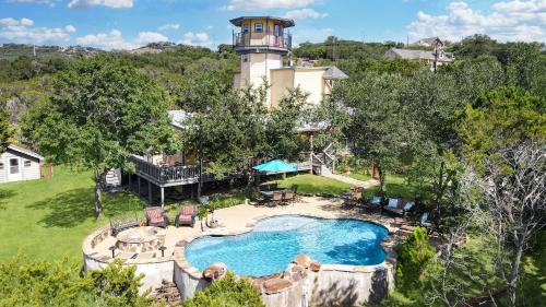 an estate with a swimming pool and a lighthouse at Canyon Lake Lighthouse in Canyon Lake
