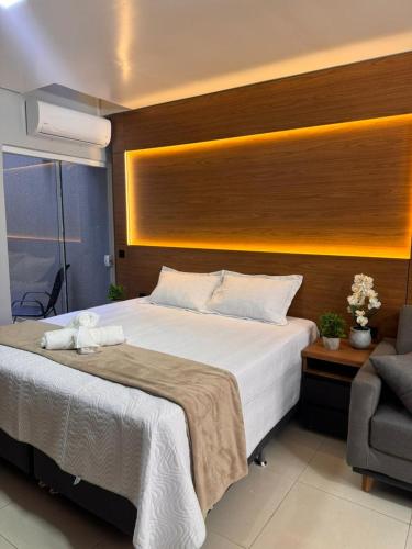 a bedroom with a large bed and a chair at Uruguaiana House in Uruguaiana