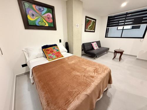 a hospital room with a bed and a chair at Total Comfort Studio Santa Rosa in Santa Rosa de Cabal