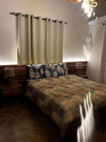 a bedroom with a bed and a curtain at 44 Inn in Dahab