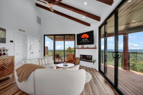 a living room with a white couch and a fireplace at Canyon Tree House in Canyon Lake