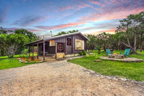 a small cabin in a field with a table and chairs at Canyon Vista in Wimberley