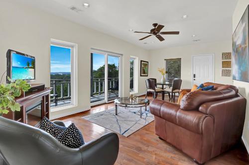a living room with a leather couch and a television at Casa Cielo in Wimberley