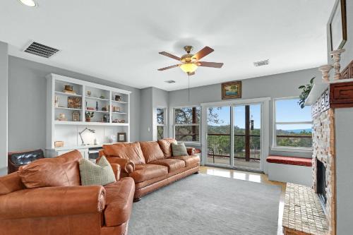 a living room with a couch and a ceiling fan at Casa Robles- The Bluebonnet in Wimberley