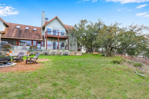 a large house with a yard with a bench at Casa Robles- The Mockingbird in Wimberley