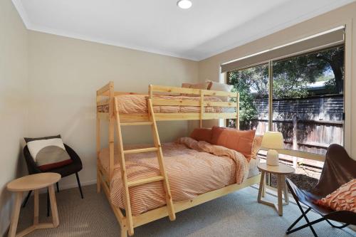 a bedroom with a bunk bed and a window at Cowes Monash Hideaway in Cowes