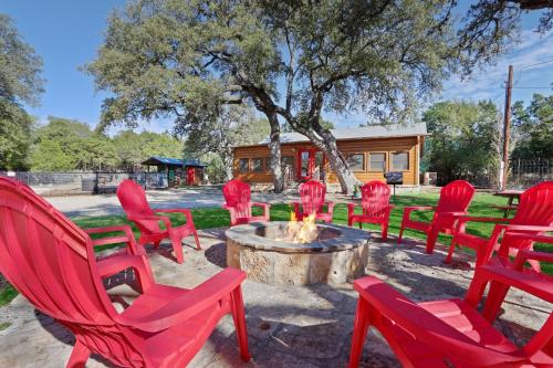 a group of red chairs around a fire pit at Wimberley Log Cabins Resort and Suites- Unit 7 in Wimberley