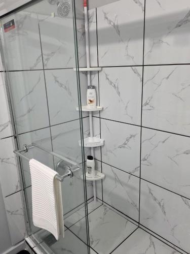 a shower with a glass door with a towel at Private guest rooms & baths in Atlanta