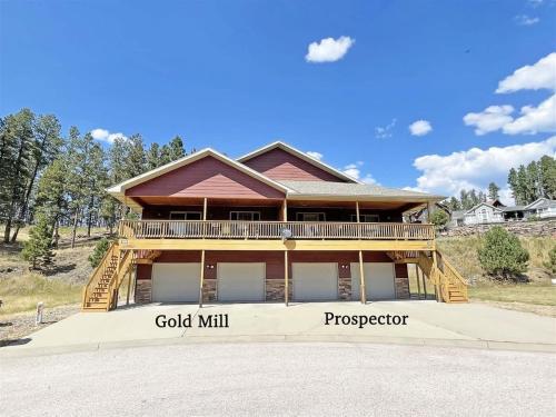 a large wooden house with a large deck at Prospector in Hill City