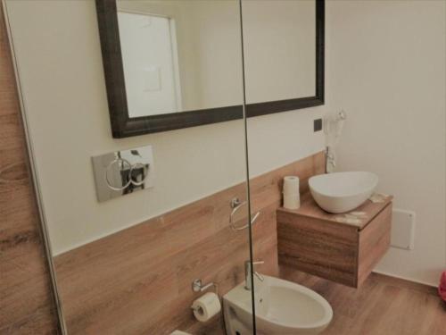 a bathroom with a sink and a toilet and a mirror at Hotel Noto Marina Meeting Vista Mare in Noto Marina