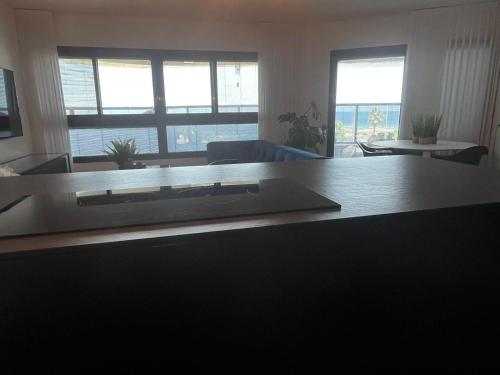 a living room with a couch and a table at Sea180 in Nahariyya