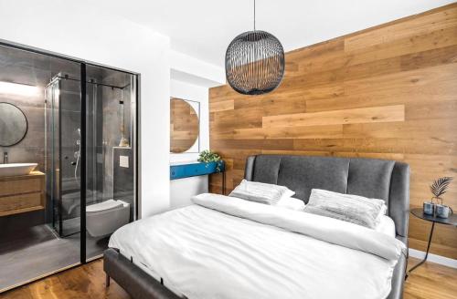 a bedroom with a bed and a shower and a sink at Sea180 in Nahariyya