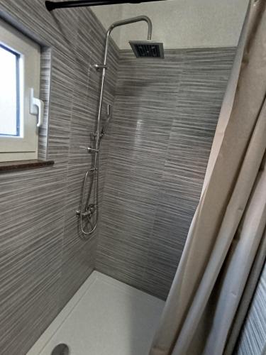 a shower with a glass door in a bathroom at Kuća za odmor STIPE in Pag
