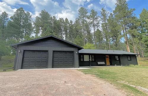 a building with two garage doors and a gravel driveway at Keystone Crossing in Keystone